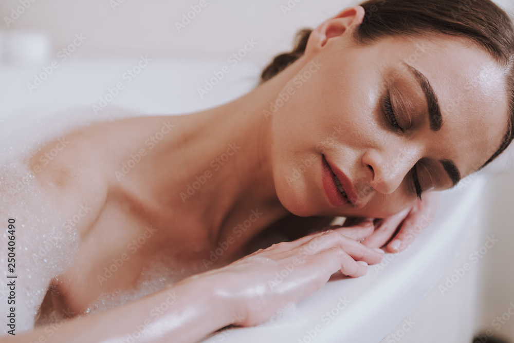 Delighted nice woman relaxing in the bathroom Delighted nice woman relaxing in the bathroom