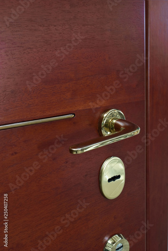 Red Wood Door With Gold Key Lock And Handle photo