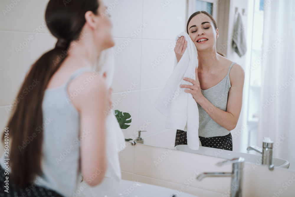 Delighted young woman is using her towel