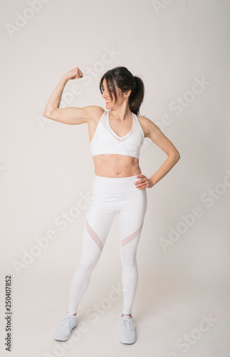 Girl with a sports outfit and white background © karrastock