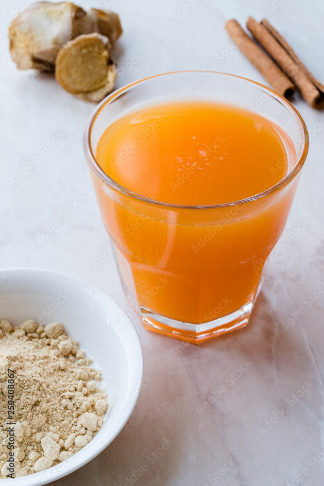 Jamu Healthy Asian Drink with Turmeric and Cinnamon Stick, Orange Juice Jamu Healthy Asian Drink with Turmeric and Cinnamon Stick, Orange Juice
