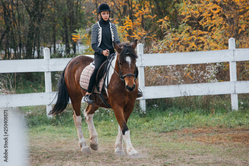 teenage girl riding horse outdoor
