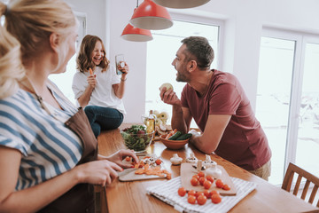 Blond lady cooking dinner and spending time with family