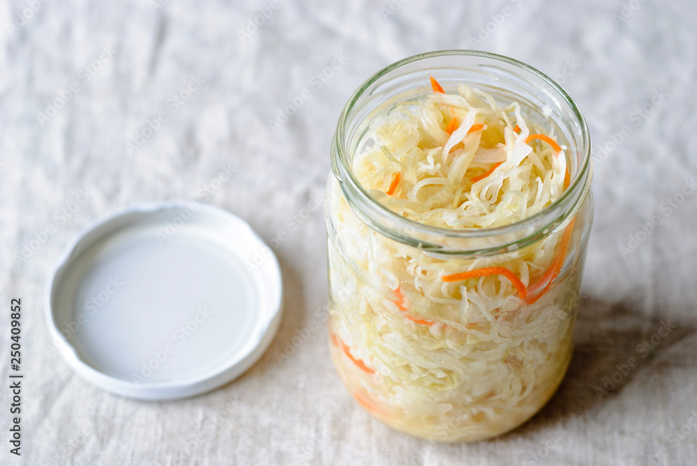 From above of glass jar filled with healthy fermented vegetables of cabbage and carrot From above of glass jar filled with healthy fermented vegetables of cabbage and carrot