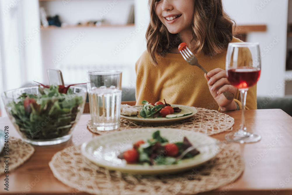 Smiling child in yellow sweater having dinner at home Smiling child in yellow sweater having dinner at home