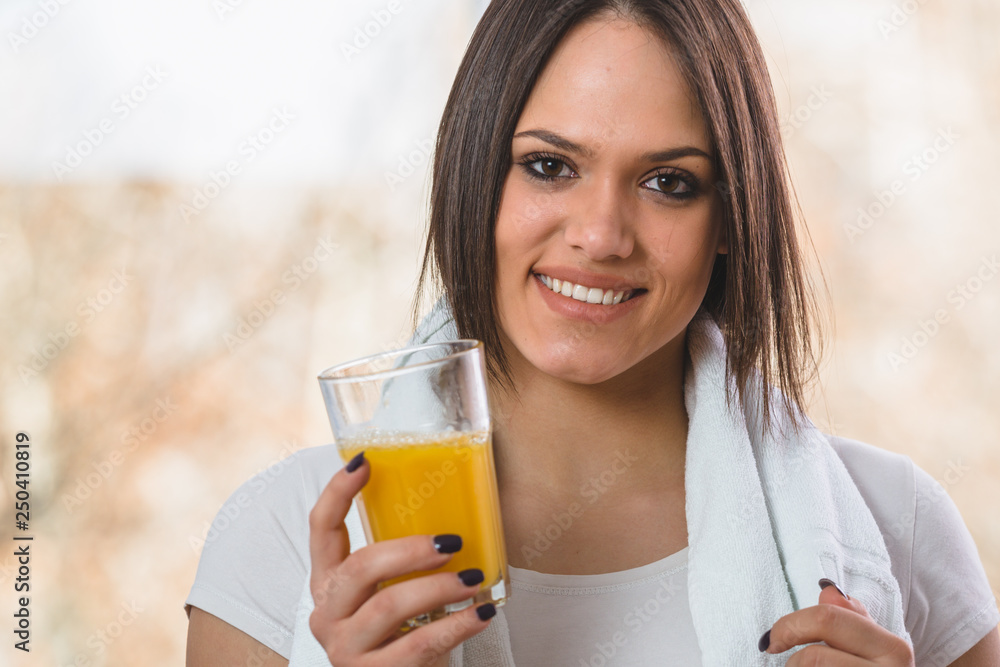 portrait of pretty woman holding glass of orange juice and looking at camera portrait of pretty woman holding glass of orange juice and looking at camera