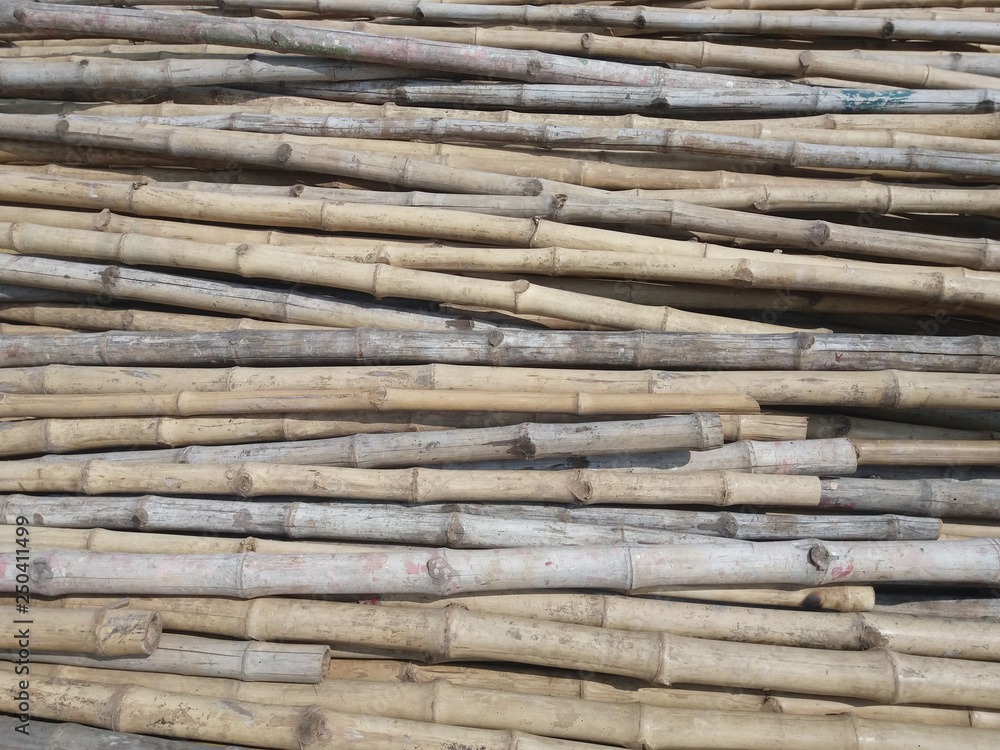 Stack of old brown bamboo wooden texture for background or industrial material Stack of old brown bamboo wooden texture for background or industrial material
