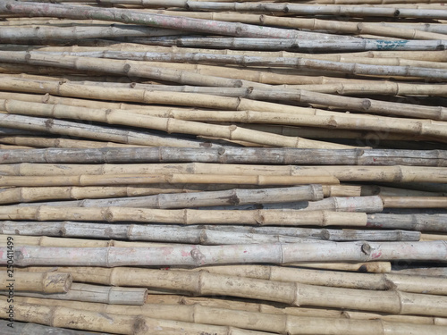 Stack of old brown bamboo wooden texture for background or industrial material