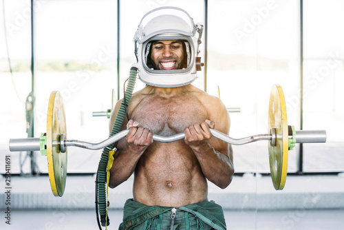 Astronaut man who picks up weights at the gym