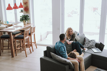 Happy family spending time together at their modern cozy house