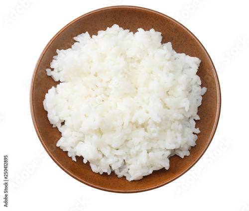 White rice in brown bowl isolated on white background. top view