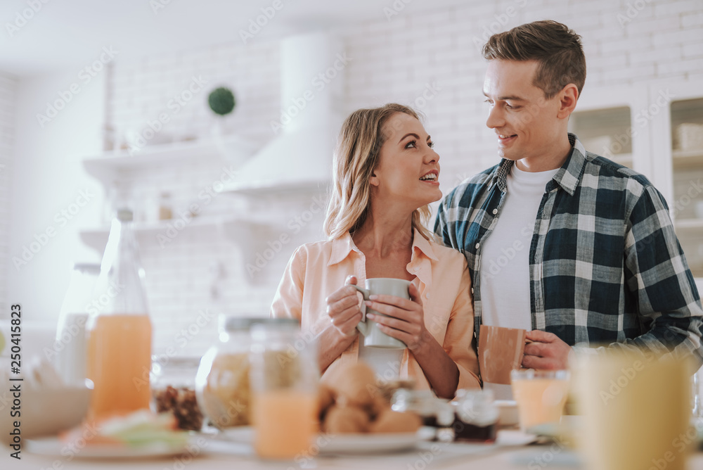 man and woman looking at each other while standing it the kitchen man and woman looking at each other while standing it the kitchen