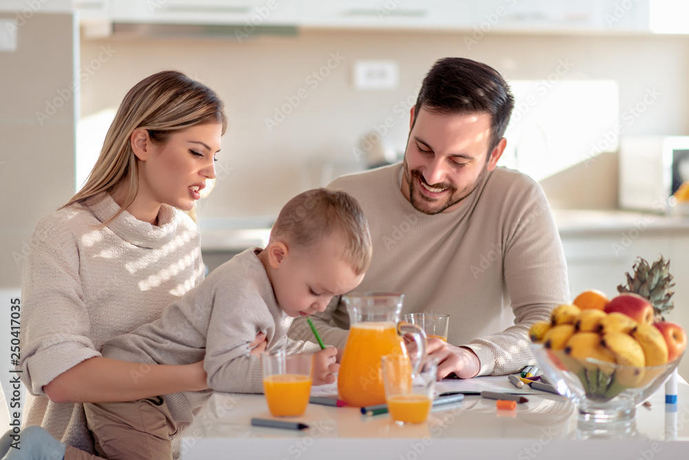 Family with child having fresh fruit juice at home
