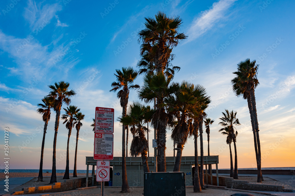 Obraz premium Warning signs outside public toilet facitities on Newport beach in southern California