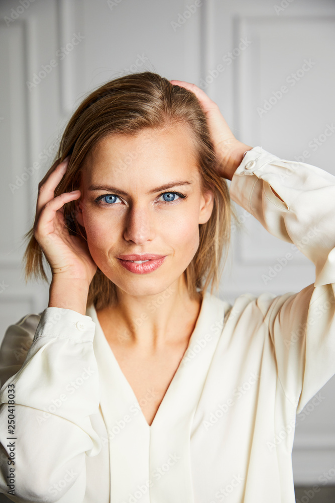 Beautiful blond woman with hands in hair, portrait Beautiful blond woman with hands in hair, portrait