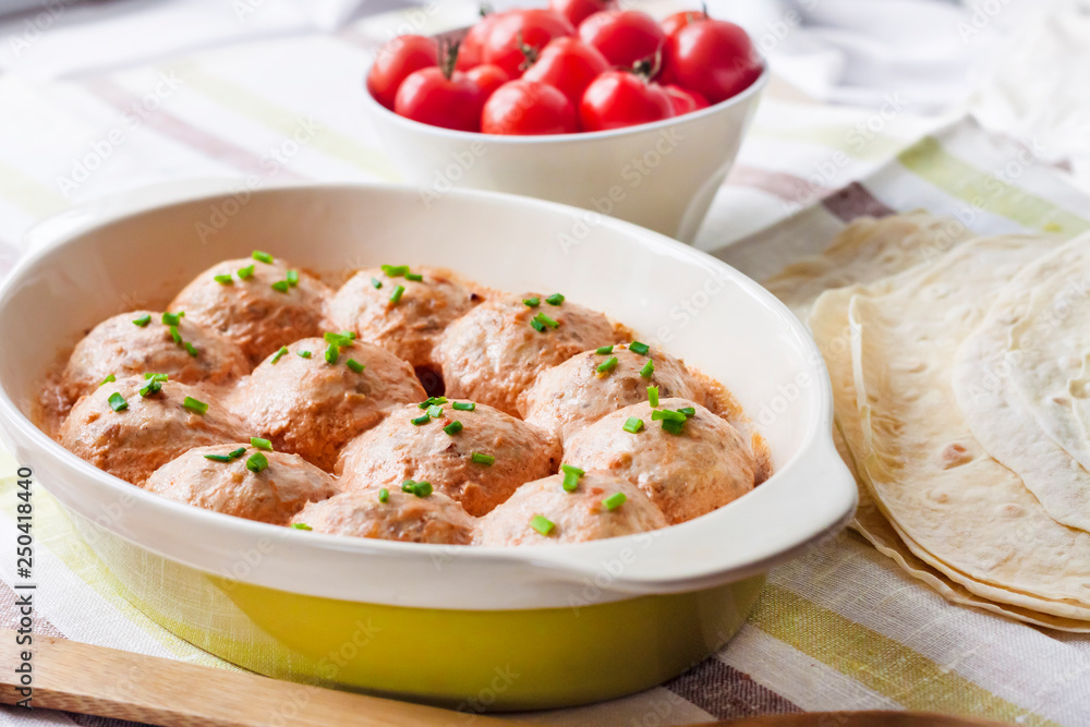 Chicken meatballs baked in creamy tomato sauce Chicken meatballs baked in creamy tomato sauce