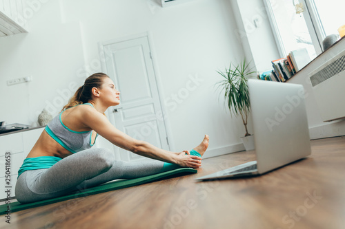Young woman practicing head to knee yoga pose