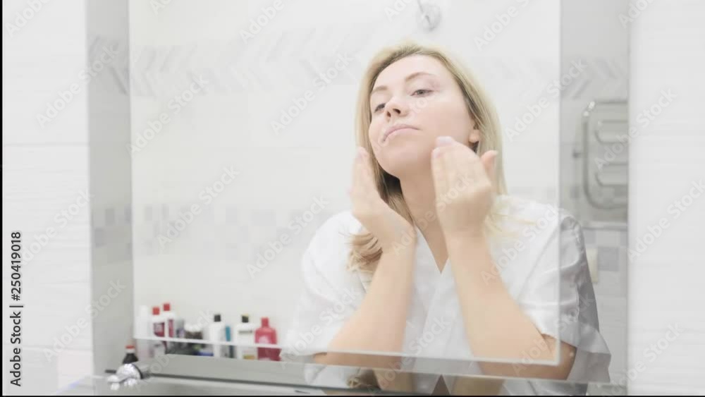 beautiful girl applying anti-aging face cream beautiful girl applying anti-aging face cream