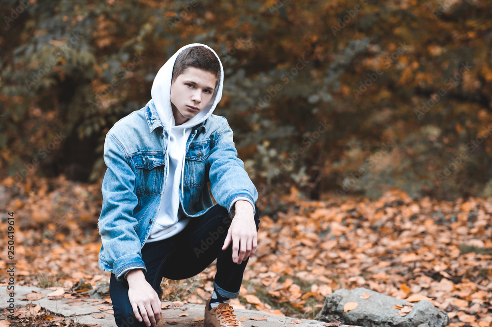 Handsome teen boy 14 16 year old wearing stylish clothes outdoors. Looking at camera. Stock Photo Adobe Stock