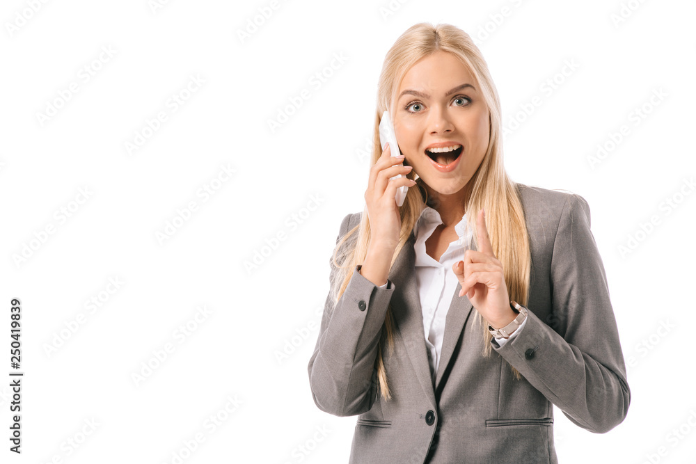 excited businesswoman having idea and pointing up while talking on smartphone isolated on white excited businesswoman having idea and pointing up while talking on smartphone isolated on white