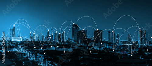 digital technology network connection concept over the city with blue tone night city scape panorama view banner photo