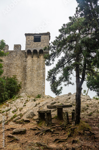 Watchtower on the wall surrounding Guaita Fortress in San Marino in the fog photo