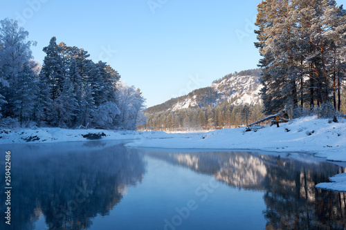 Blue Lake in the Mountain Valley of the Katun River  Chemale region. The Republic of the Mountain Altai. winter view of the lake in the mountains. fantastic nature. Winter fairy landscape.