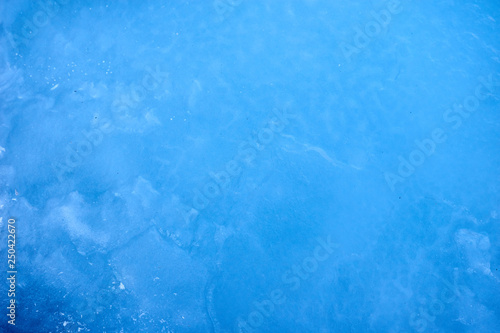 Texture blue cosmic ice with a matte effect on a lake in the