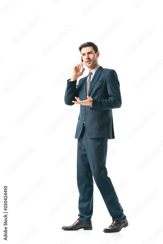 confused businessman in suit talking on smartphone isolated on white confused businessman in suit talking on smartphone isolated on white