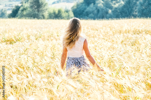 Young woman on a wheat field