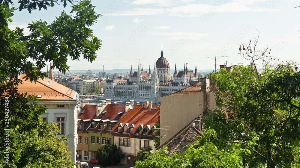Aerial view of the roofs and the Hungarian Parliament on the bank in Budapest, sunny day, Hungary