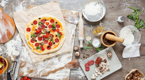 Top view cooking pizza with...
