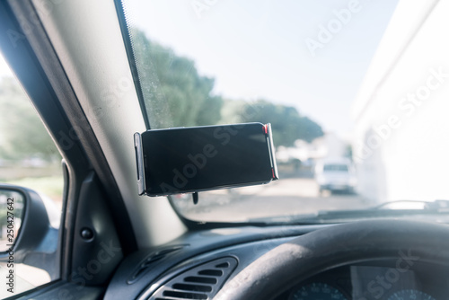 Closeup on handsfree car smartphone assistance, communication gps navigation system background. Empty display ready for digital map assistant, modern electronic equipment technology device.
