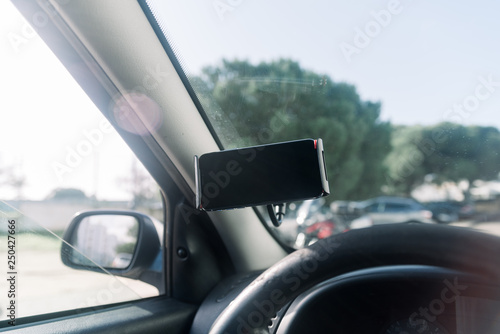 Closeup on handsfree car smartphone assistance, communication gps navigation system background. Empty display ready for digital map assistant, modern electronic equipment technology device.