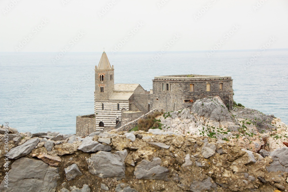 San Pietro Church (church Chiesa di San Pietro) view from the sea.  The church of Portovenere with its walls on top of a cliff near the sea. St. Peter's Church in Portovenere, La Spezia, Gulf of Poets
