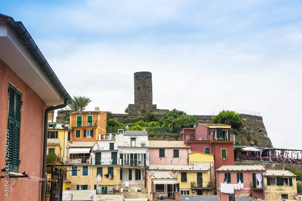 Beautiful small town of Vernazza in the Cinque Terre national Park. View on Vernazza Castello Doria the old fortress and tower at the coastal hill of town Vernazza. Italian colorful landscapes.