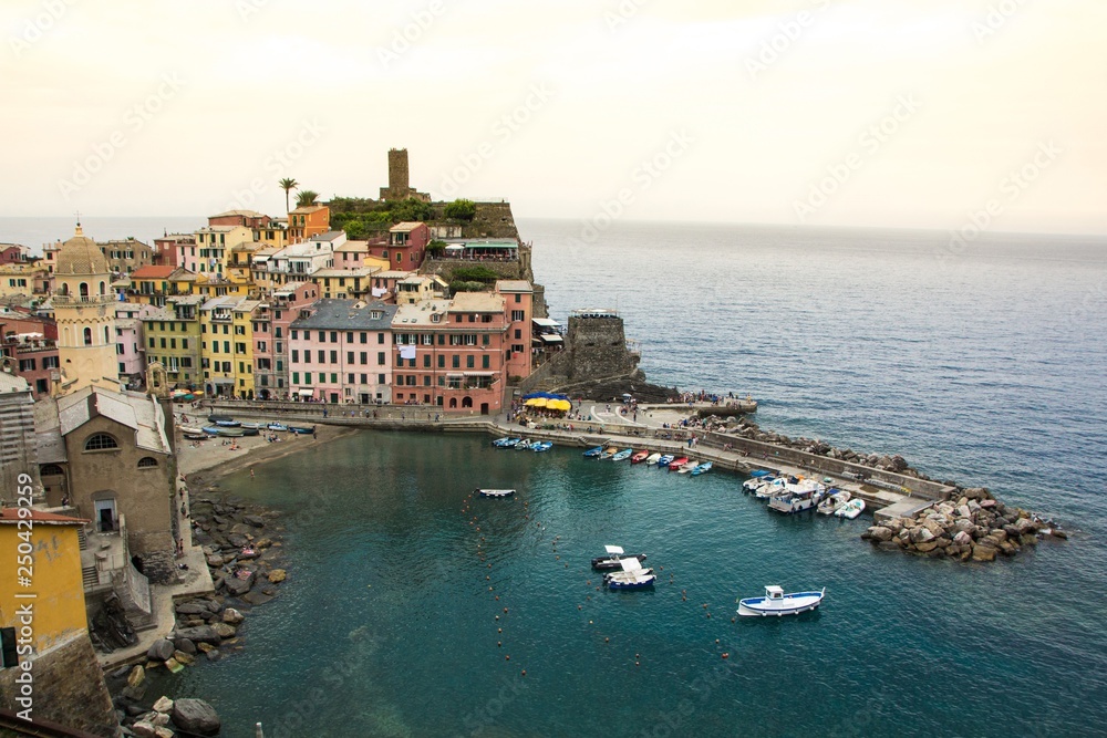 Beautiful small town of Vernazza in the Cinque Terre national Park. View on Castello Doria the old fortress and tower at the coastal hill of Vernazza. Beautiful evening sunset on Cinque Terre.