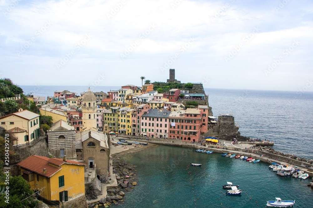 Beautiful small town of Vernazza in the Cinque Terre national Park. View on Vernazza Castello Doria the old fortress and tower at the coastal hill of town Vernazza. Italian colorful landscapes.