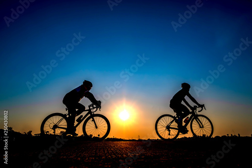 Fototapeta Naklejka Na Ścianę i Meble -  Silhouette of cyclist in sunset background.