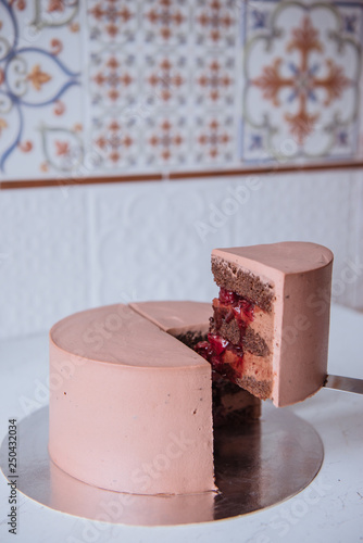 Naked wedding birthday cake. Rustic layer homemade cake with cream. Dessert decorated with chocolate and fruits. Selective focus. Piece of cake. Vegan raw cake.