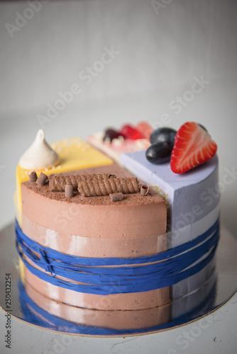 Naked wedding birthday cake. Rustic layer homemade cake with cream. Dessert decorated with chocolate and fruits. Selective focus. Piece of cake. Vegan raw cake.