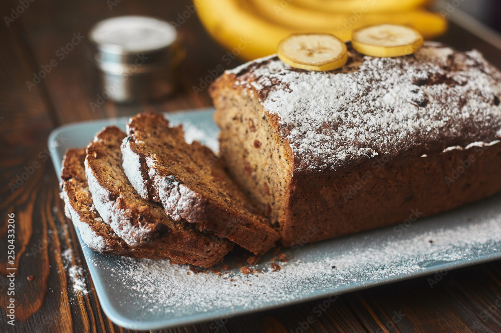 homemade sliced banana cake decorated with sugar powder and three banana homemade sliced banana cake decorated with sugar powder and three banana