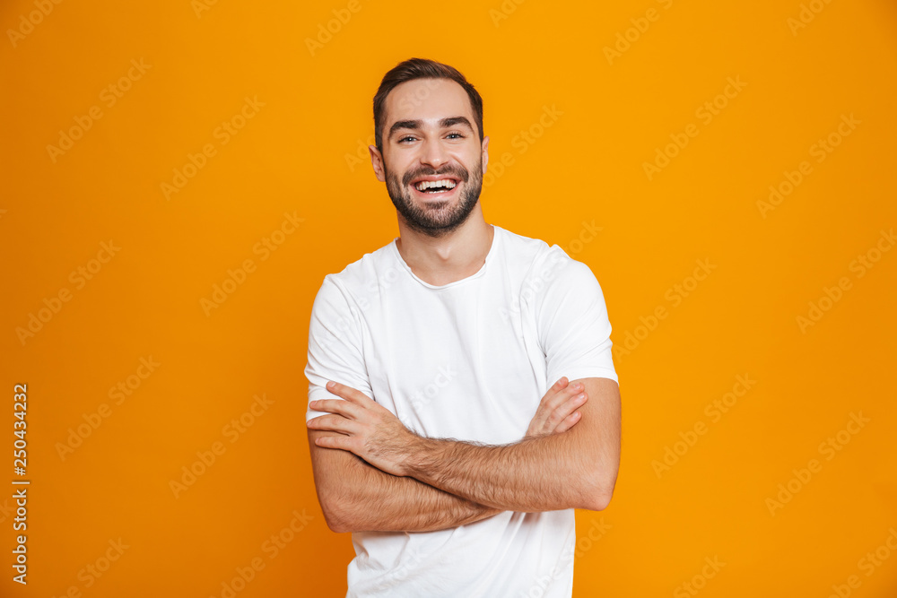 Image of brunette man 30s with beard and mustache smiling while standing, isolated over yellow background Image of brunette man 30s with beard and mustache smiling while standing, isolated over yellow background