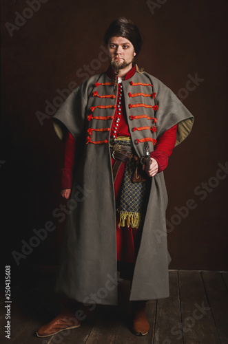 Portrait of a man in a medieval costume on a dark background. Clothes of the Polish gentry.