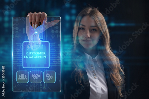 The concept of business, technology, the Internet and the network. A young entrepreneur working on a virtual screen of the future and sees the inscription: Customer engagement