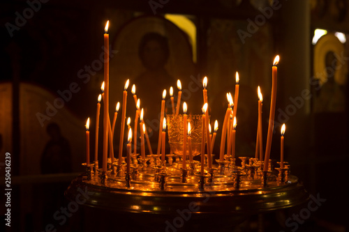 Candles are burning, stand in the church candlestick. Temple.