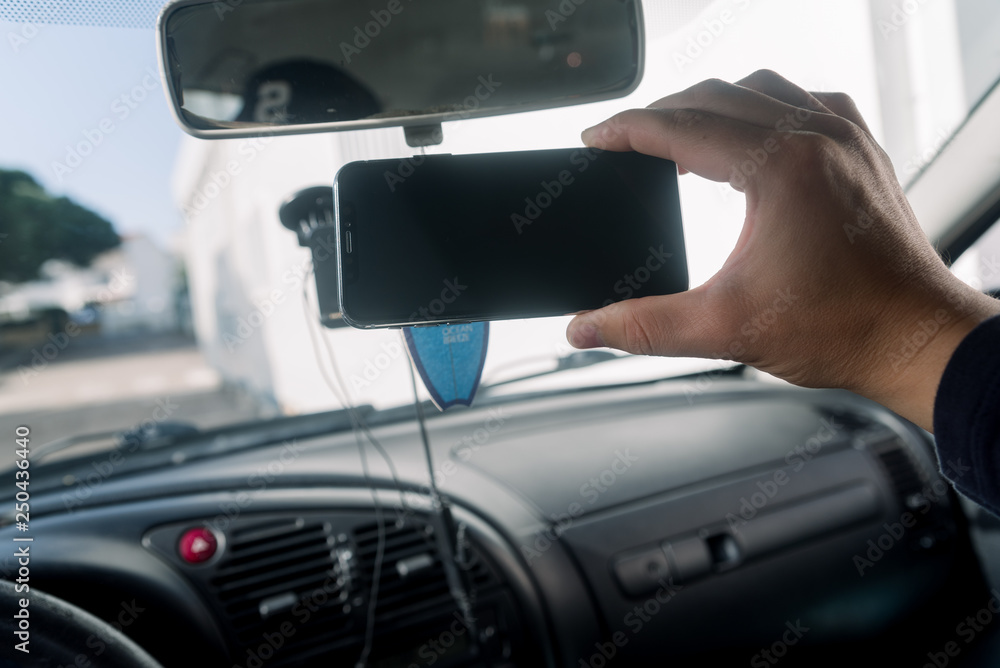 Closeup on hand holding smartphone for assistance, car communication gps navigation system background. Empty display ready for digital map assistant, modern electronic equipment technology device. Closeup on hand holding smartphone for assistance, car communication gps navigation system background. Empty display ready for digital map assistant, modern electronic equipment technology device.