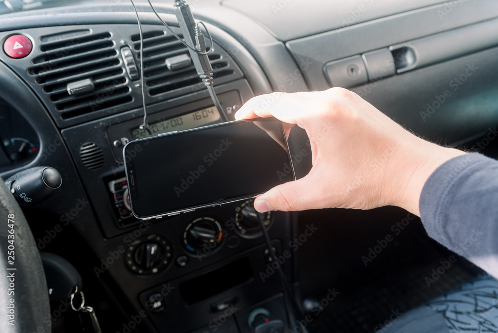 Closeup on hand holding smartphone for assistance, car communication gps navigation system background. Empty display ready for digital map assistant, modern electronic equipment technology device.