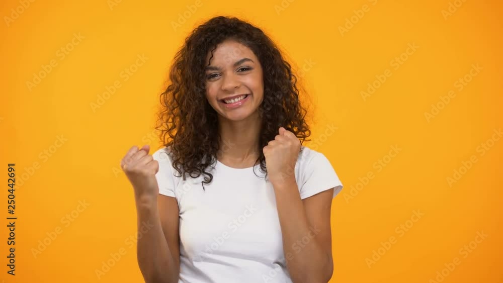 Smiling black girl doing success gestures and saying yes at camera, happiness Smiling black girl doing success gestures and saying yes at camera, happiness