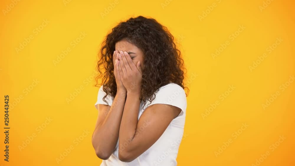 Frightened biracial woman watching horror movie, closing face with hands, fear Frightened biracial woman watching horror movie, closing face with hands, fear